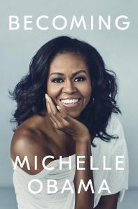 A woman smiling with the words Becoming by Michelle Obama